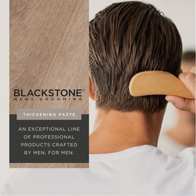 Blackstone paste on hands being applied to hair for pliable hold and styling control
