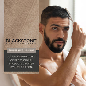 Blackstone pomade in hand during application demonstrating even distribution and volume