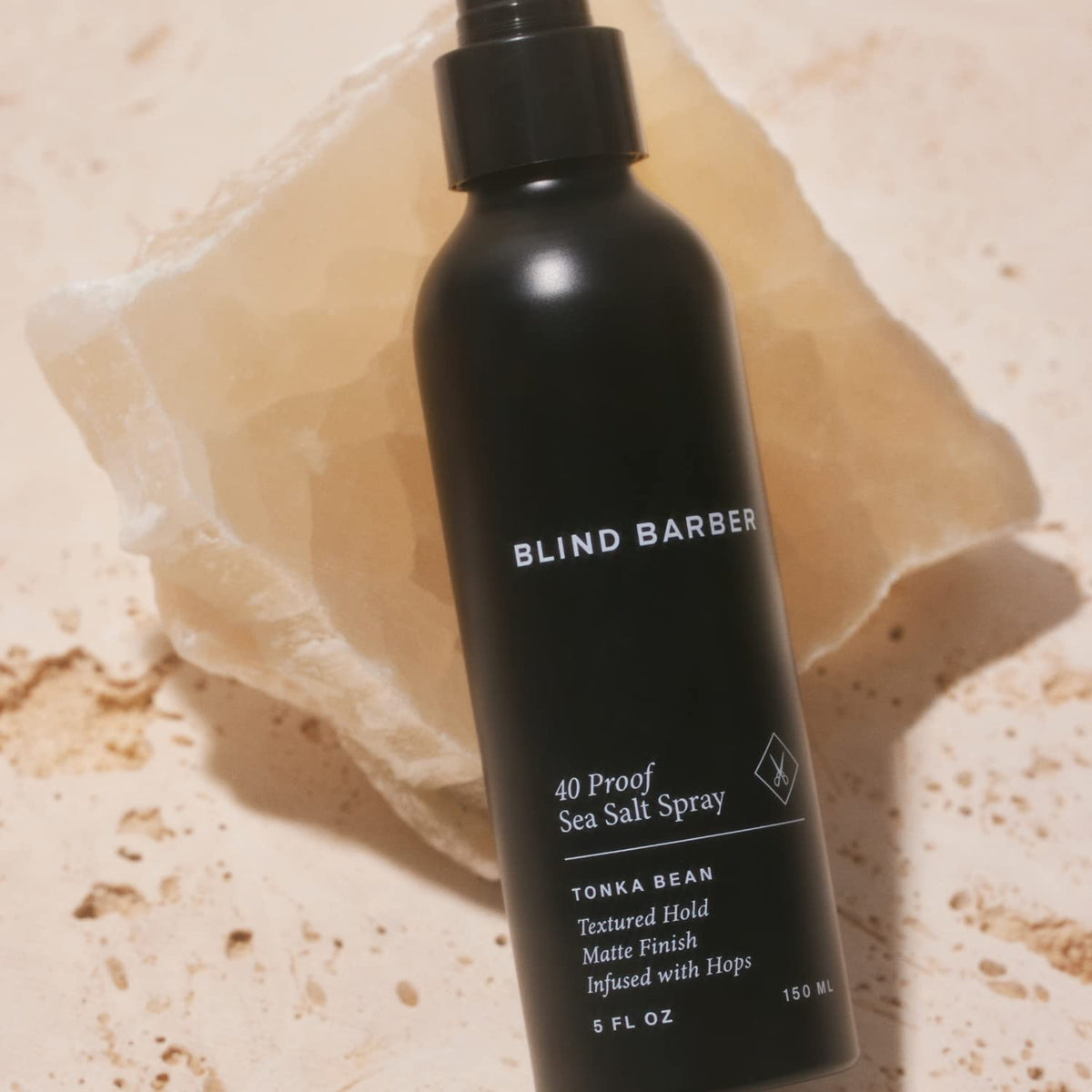 Blind Barber bottle held in hand showing size and travel-friendly convenience