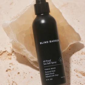 Blind Barber bottle held in hand showing size and travel-friendly convenience