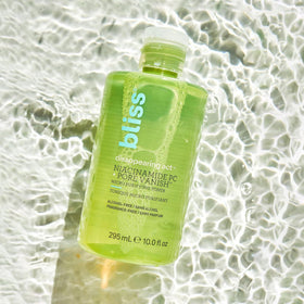 Bliss bottle next to common items to show 10 fl oz scale and value