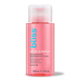Bliss bottle next to measuring scale showing 7 fl oz travel-friendly size