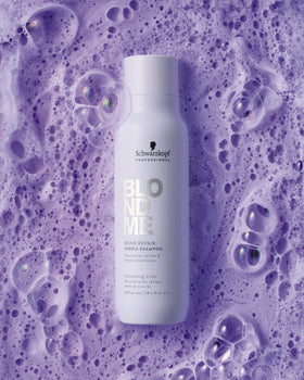 Applying BlondMe shampoo to wet hair to neutralize brass and hydrate