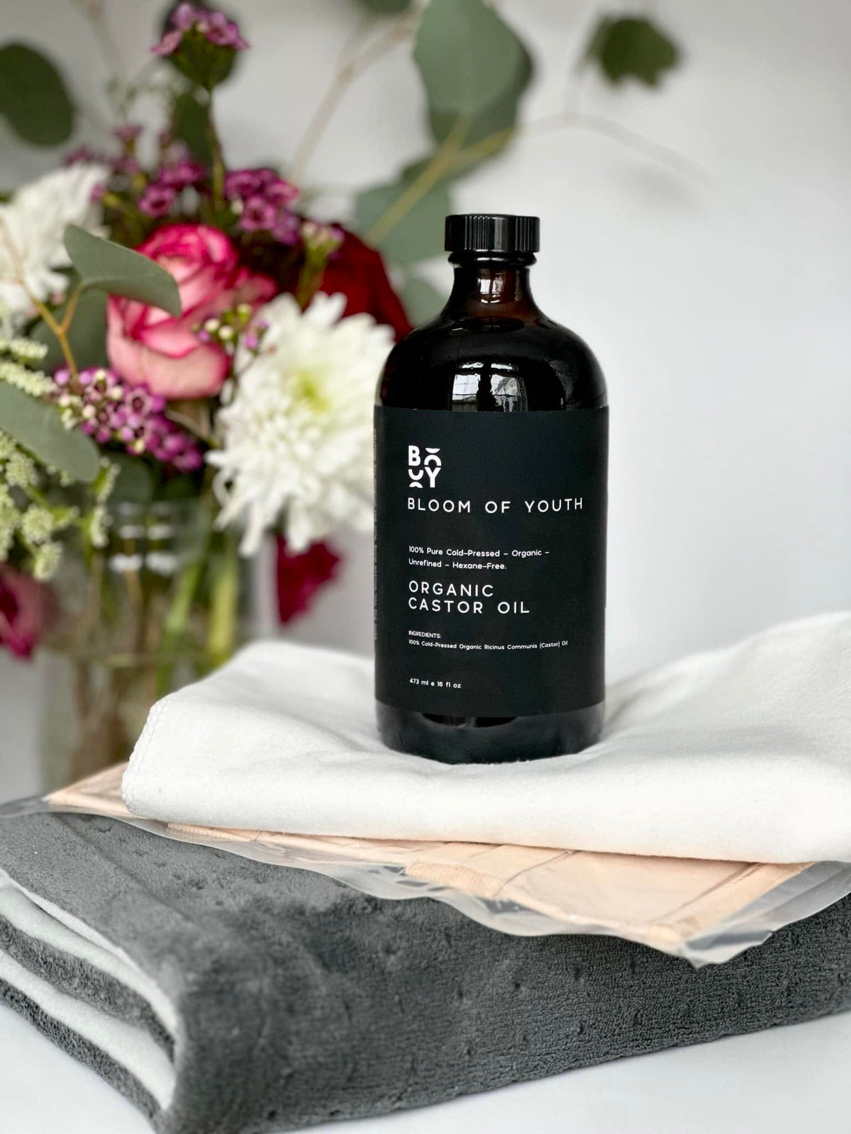 Bloom of Youth applied in castor oil pack scene for soothing topical benefit