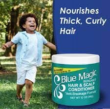 Hand applying Blue Magic to hair roots demonstrating targeted scalp care and easy use