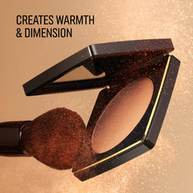 Bobbi Brown applying bronzer on model cheeks to sculpt and define features