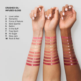Bobbi Brown gloss in a purse beside everyday items showing portability and quick-touchup benefit