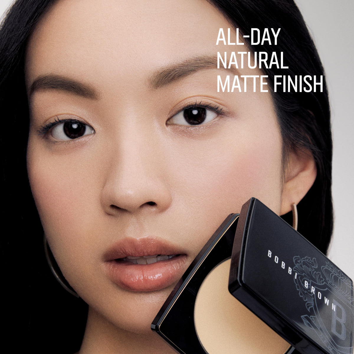 Bobbi Brown compact in hand indicating true size and easy travel-friendly pocket fit