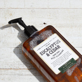 Body Prescriptions bottle on bathroom counter staged with towel, conveys everyday home use and scent appeal