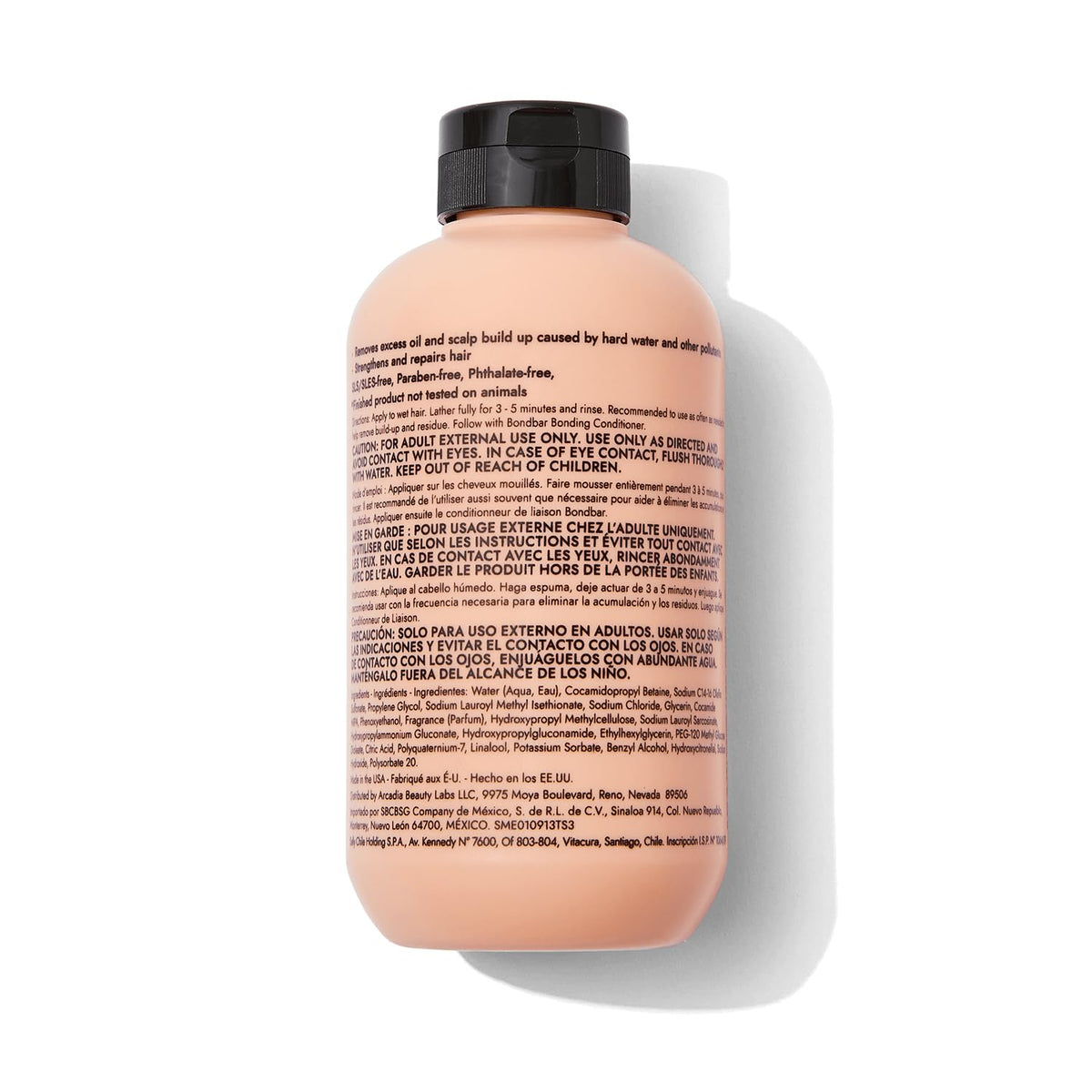 Bondbar clarifying shampoo in bathroom setting beside towel, demonstrates use for removing buildup