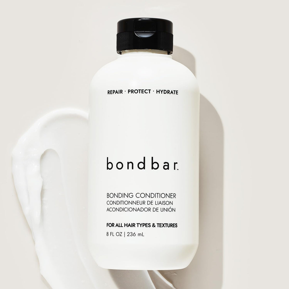 Wet hair in shower being conditioned with Bondbar for smoother detangle