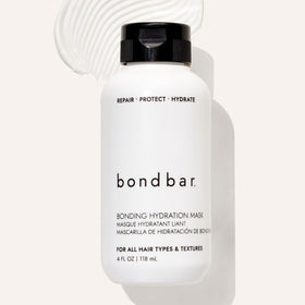 Bondbar 4 fl oz bottle held in hand showing compact travel-friendly size
