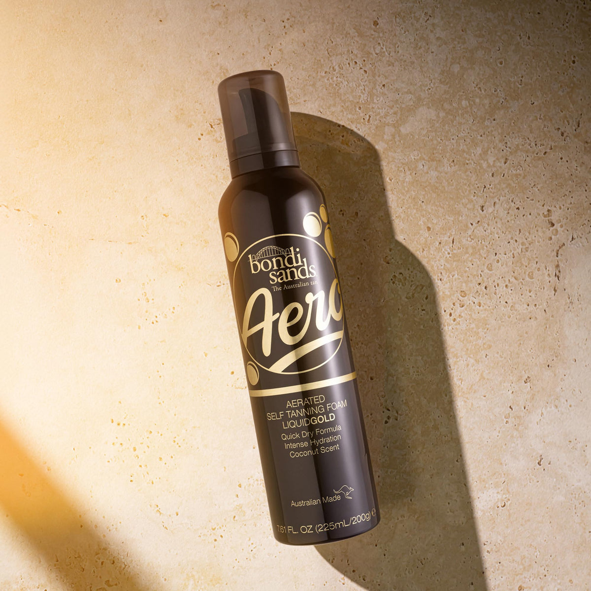 Bondi Sands 225ml bottle next to hand for size and travel-friendly benefit