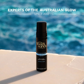 Bondi Sands bottle held in hand showing travel-friendly 200 mL size benefit