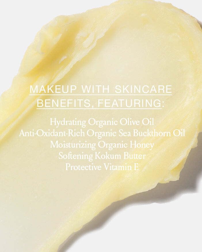 BOOM! by Cindy Joseph applying balm to cheekbone to create a natural dewy highlight