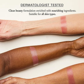 BOOM! lip swatch on hand showing sheer, buildable tint
