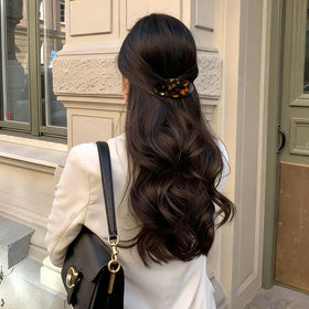 BOUNIQ two barrettes in a styled updo adding vintage accent and secure hold