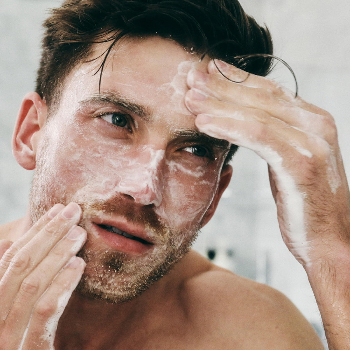 Brickell men's acne face wash next to common items showing 6 ounce size