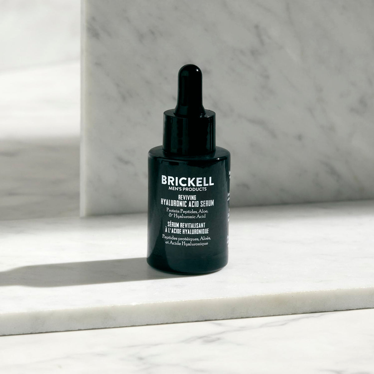 Brickell serum being applied to hands demonstrating easy use and fast feel