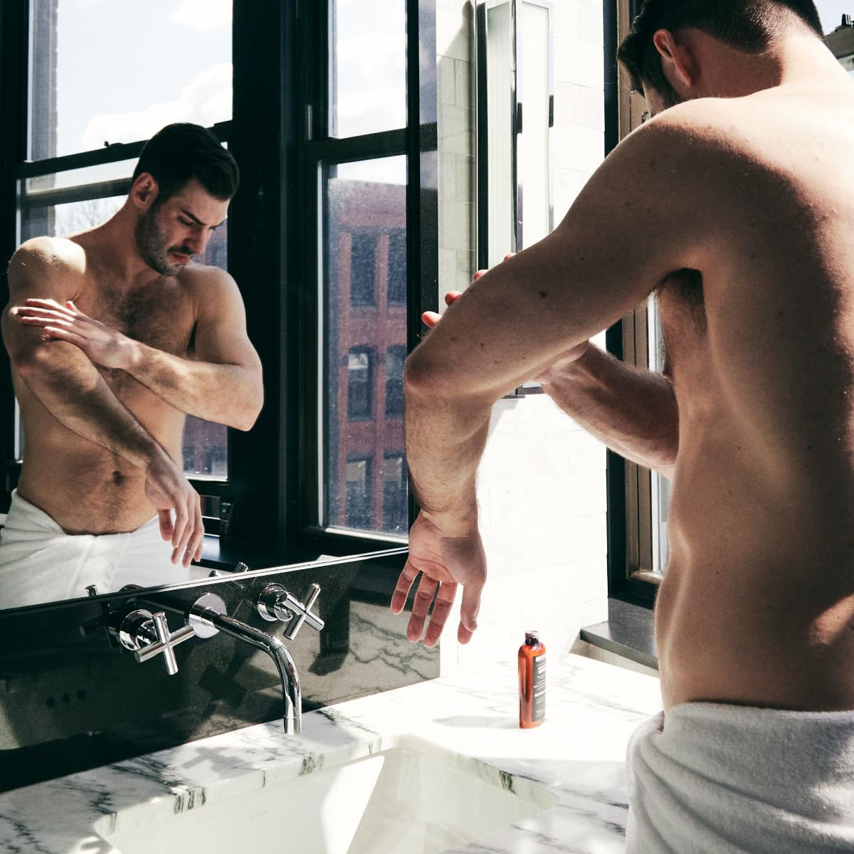 Brickell Men's Products on bathroom shelf styled in lifestyle scene showing daily routine benefit