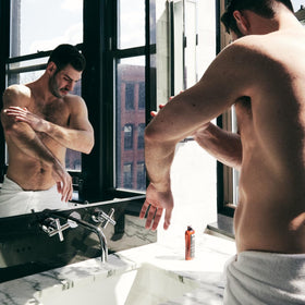 Brickell Men's Products on bathroom shelf showcasing everyday grooming benefit