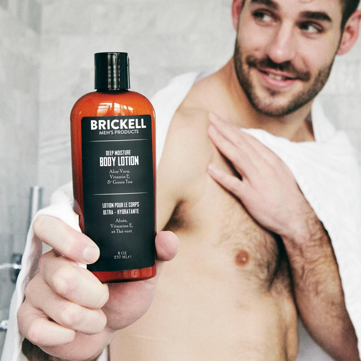 Brickell Men's Products dispensing lotion onto hand, demonstrating easy application benefit