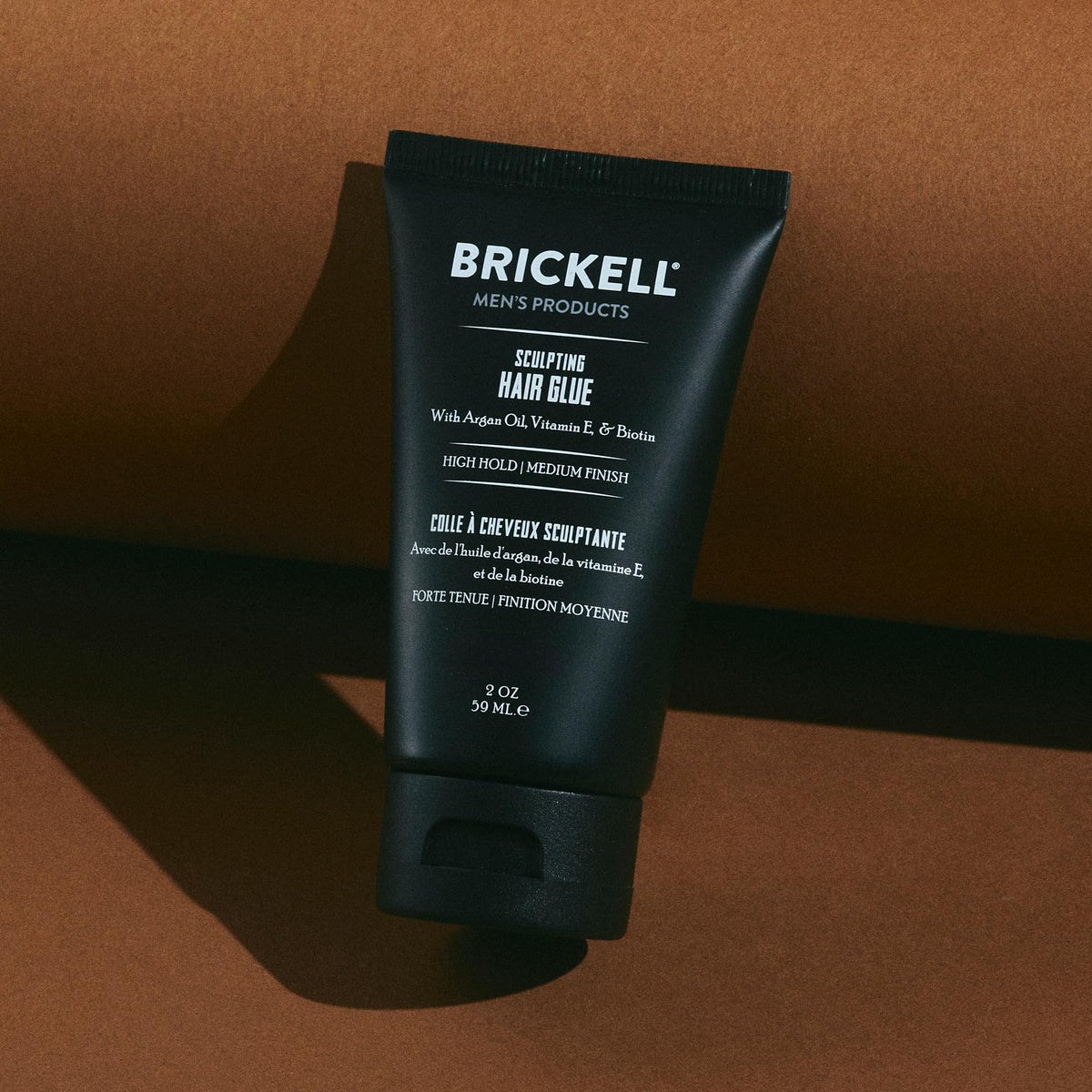 Brickell tube held in hand to show scale and convenience for travel or gym bags