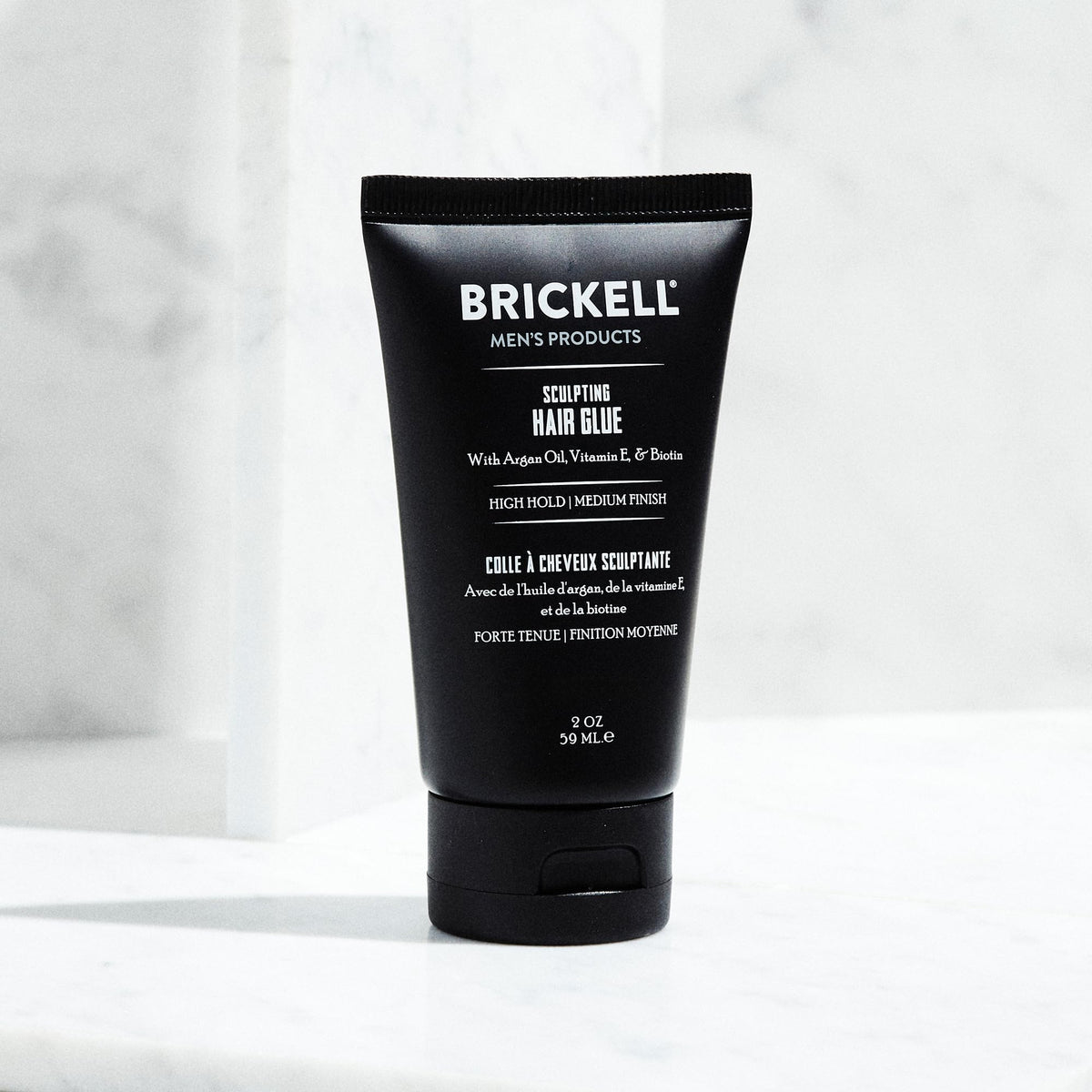 Argan oil and vitamin E beside Brickell product illustrating nourishing ingredients and protection