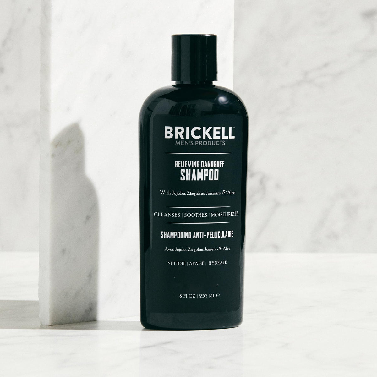 Brickell lather in hand demonstrating rich foam for effective scalp cleansing