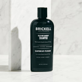 Brickell lather in hand demonstrating rich foam for effective scalp cleansing