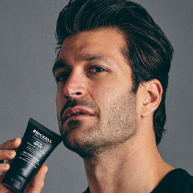 Morning bathroom scene with Brickell glue on counter suggesting daily grooming and confidence