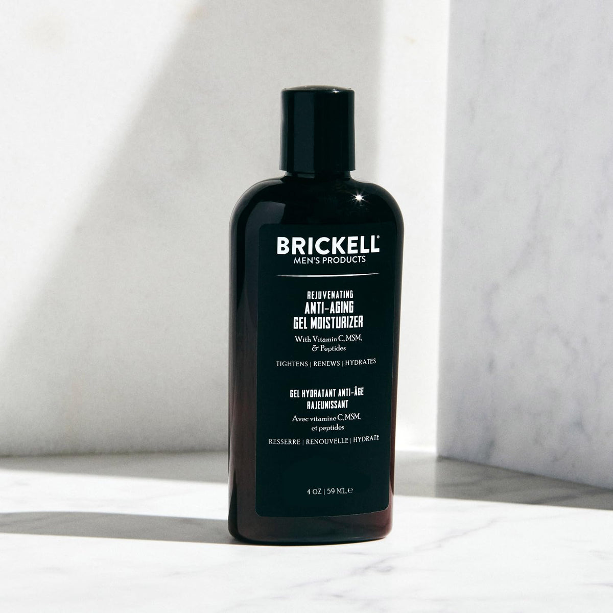 Man applying Brickell Men's gel moisturizer during a morning routine demonstrating fast absorption and non-greasy finish