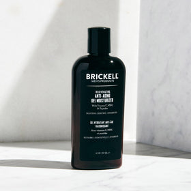 Man applying Brickell Men's gel moisturizer during a morning routine demonstrating fast absorption and non-greasy finish