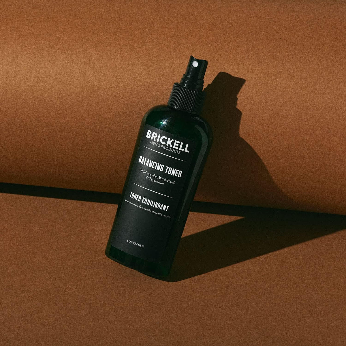 Brickell Men's Products toner close-up showing clear liquid texture and cooling cucumber benefit