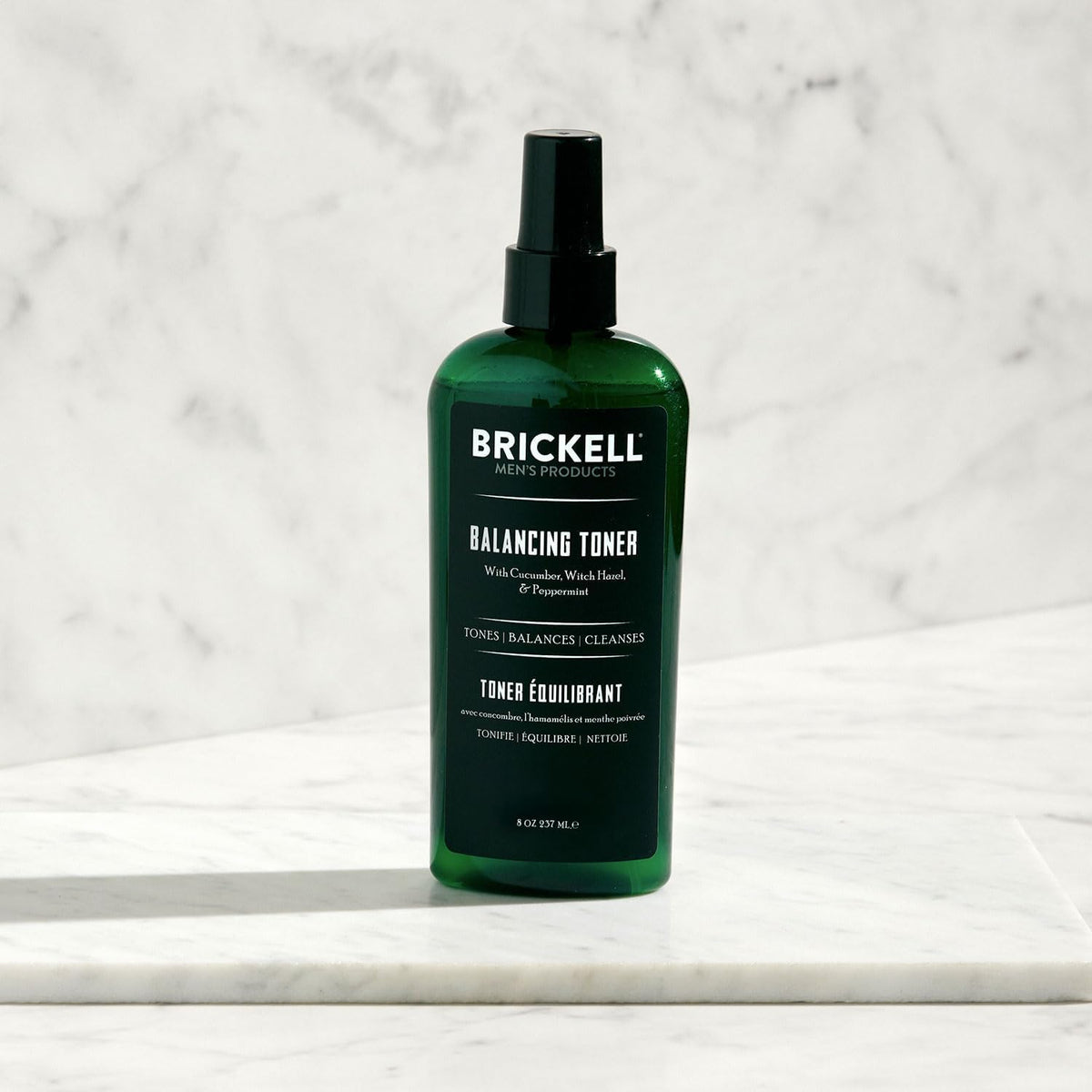 Brickell Men's Products toner in use applied with cotton pad to refresh skin and reduce shine