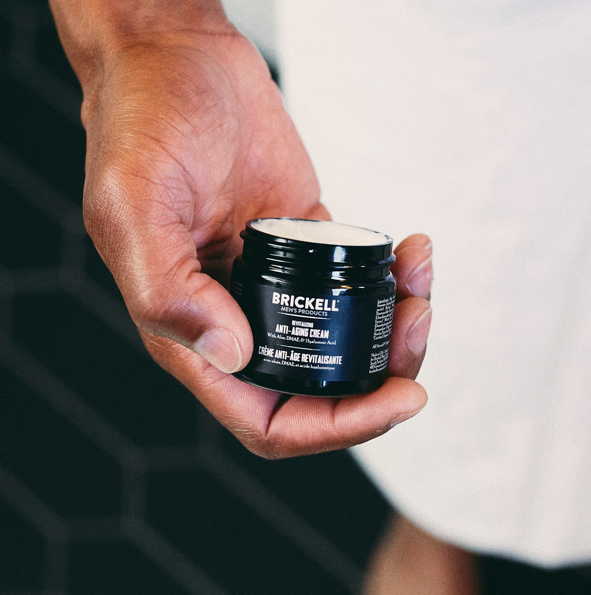 Brickell night cream jar open to show rich cream texture and overnight repair benefit