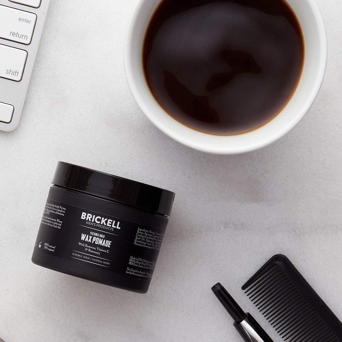 Brickell Men's pomade being warmed on hands for easy application and control