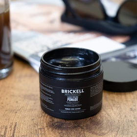Brickell Men's pomade being worked through hair for strong glossy hold