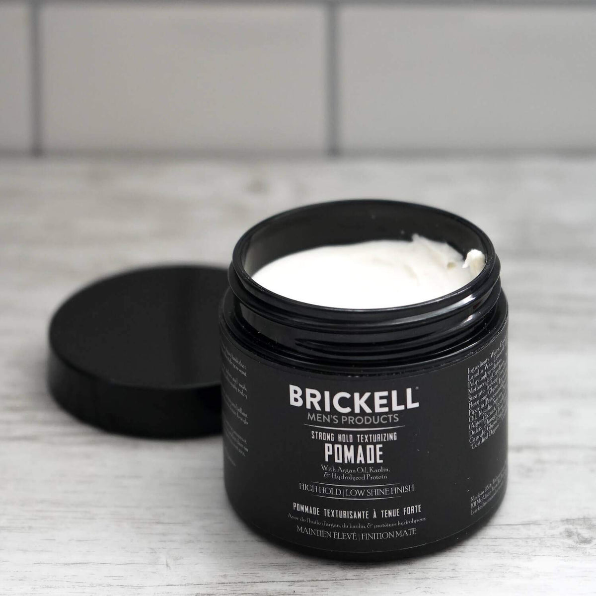 Brickell Men's Products jar on bathroom shelf showing everyday grooming convenience benefit