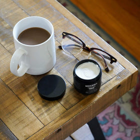 Brickell Men's Products next to a ruler showing compact 2 ounce size benefit