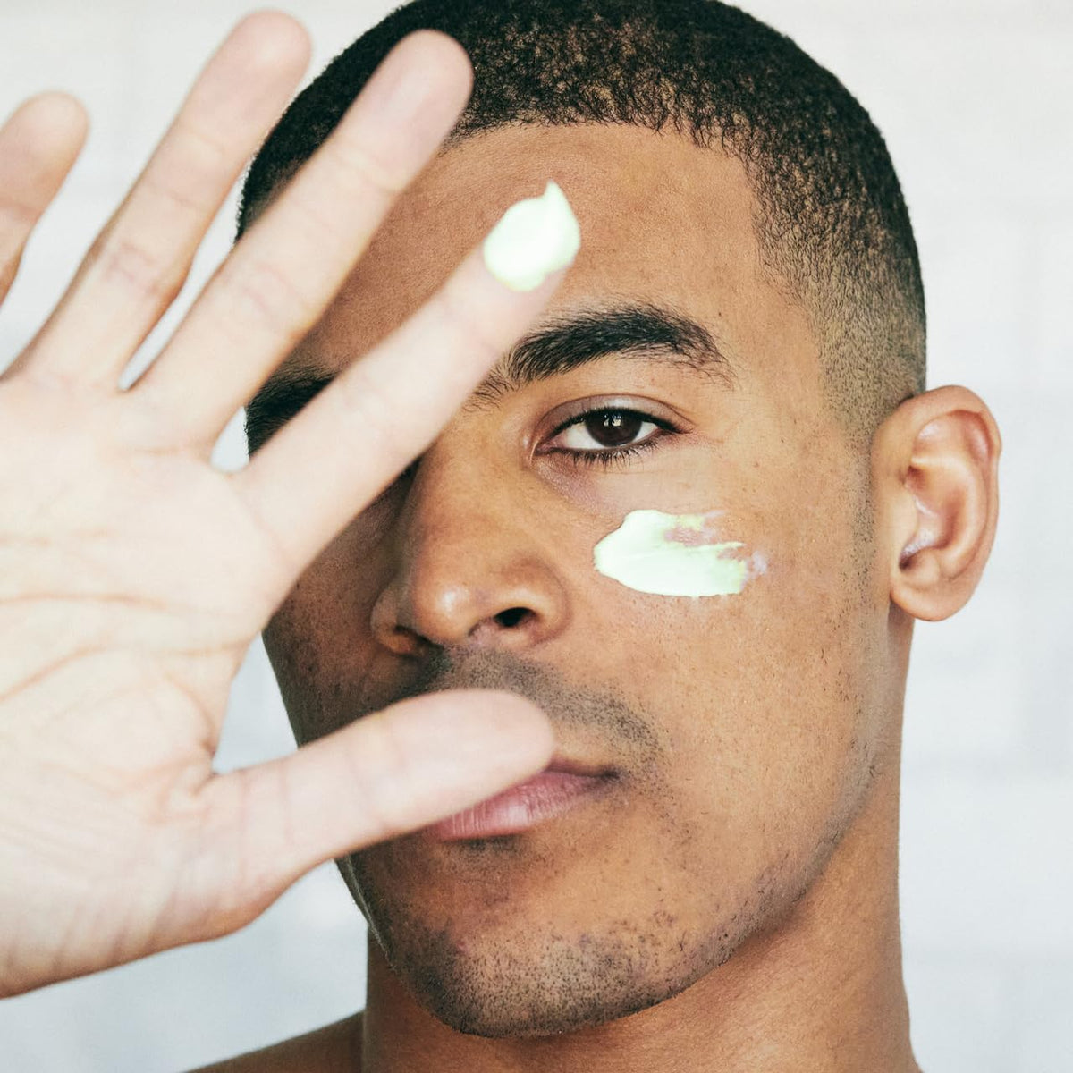 Brickell Men’s retinol cream being applied to hand demonstrating quick absorption