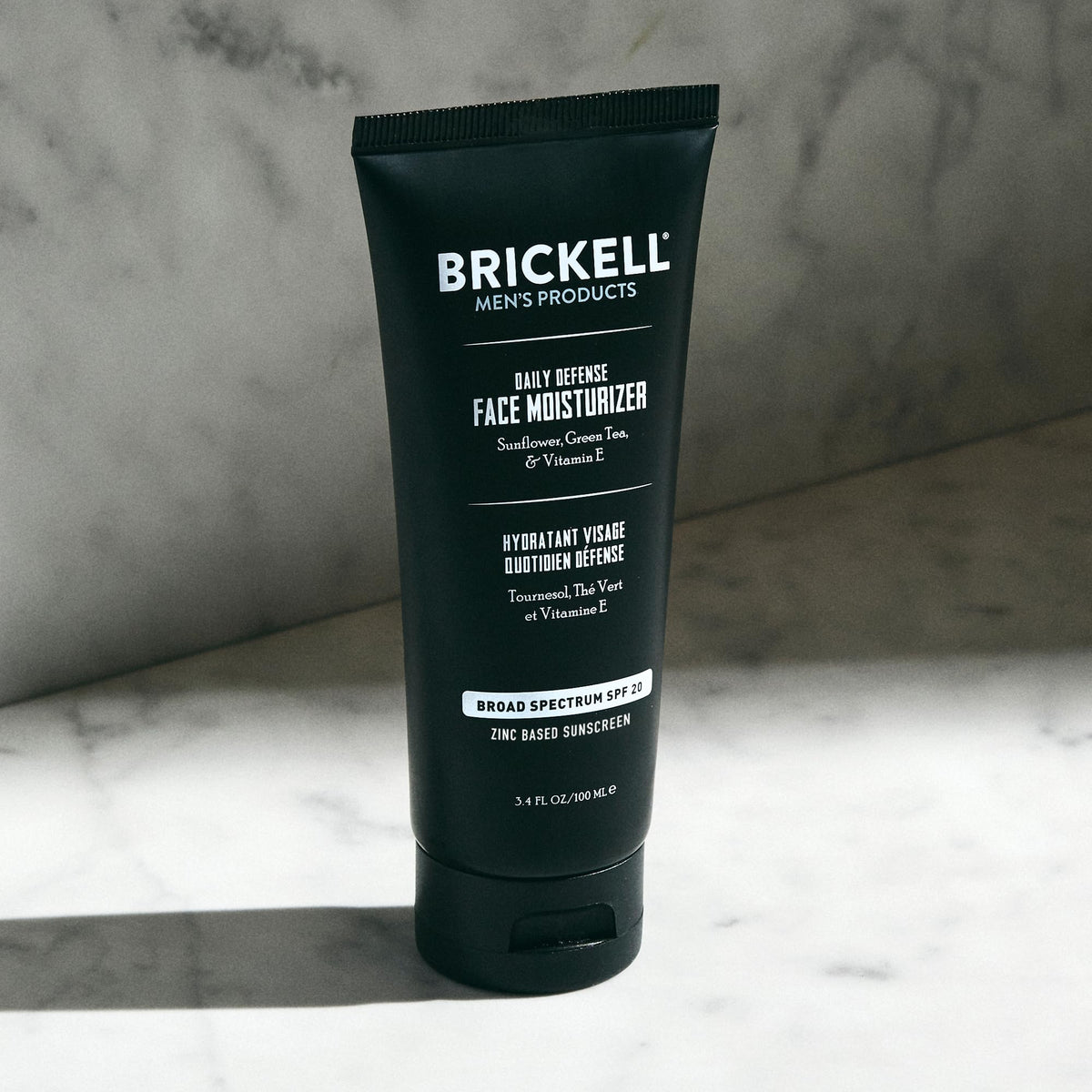 Brickell size comparison on hand illustrating travel-friendly 3.4oz benefit
