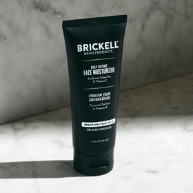 Brickell size comparison on hand illustrating travel-friendly 3.4oz benefit