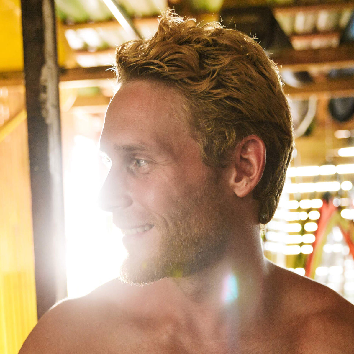 Brickell Men’s bottle on beach towel suggesting natural beach hair results