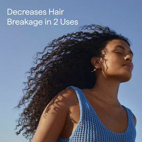 Briogeo applying to hair in shower demonstrating detangling and slip benefit