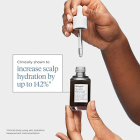 Briogeo bottle held in hand to show 1 oz scale and travel-friendly size