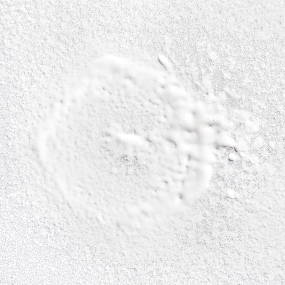 Briogeo bottle spraying mist, demonstrating even lightweight application benefit