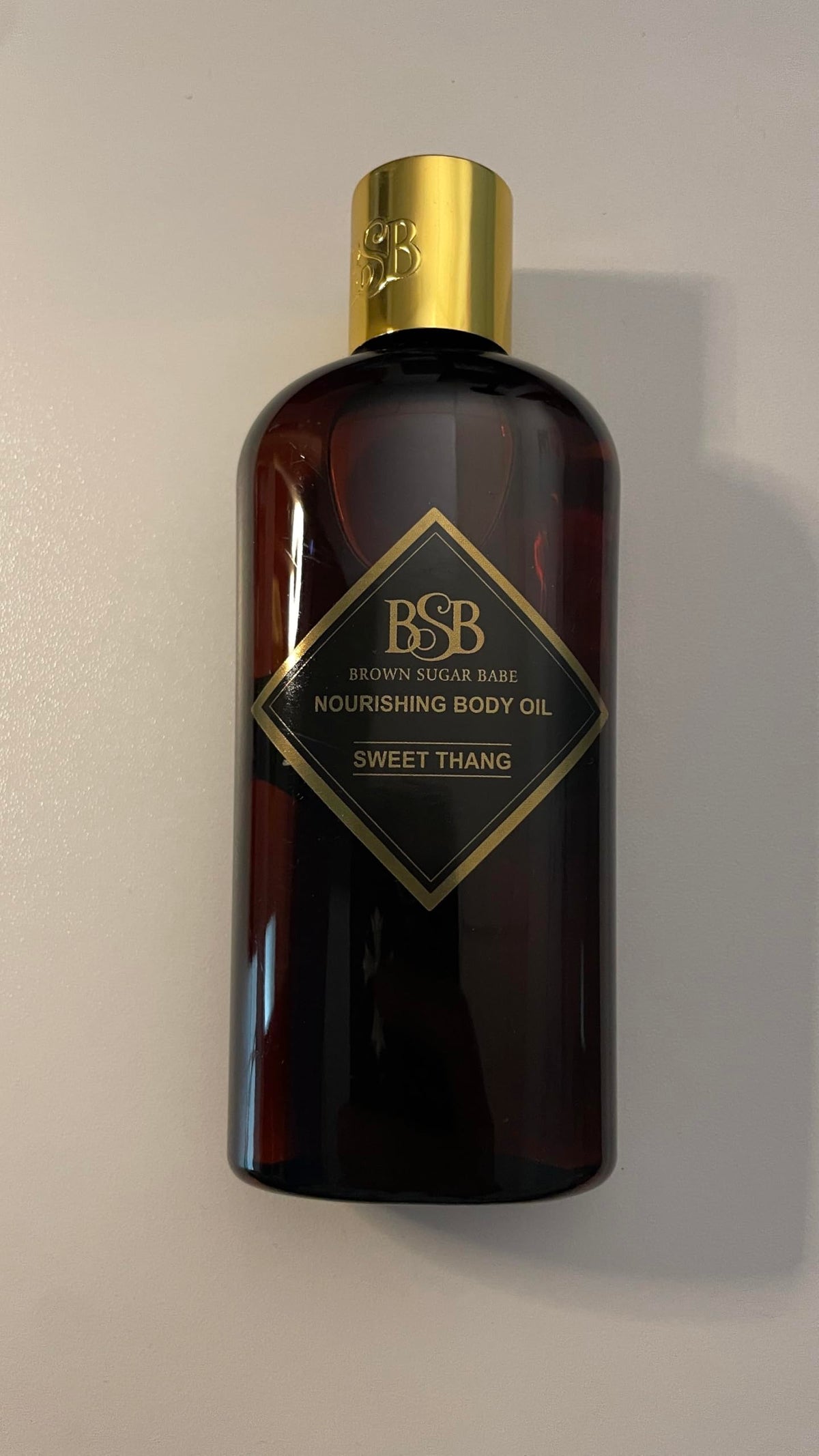 Brown Sugar Babe bottle on bathroom shelf suggesting daily skincare ritual