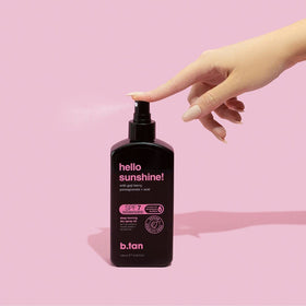 B.TAN mist sprayed from hand demonstrating quick outdoor application