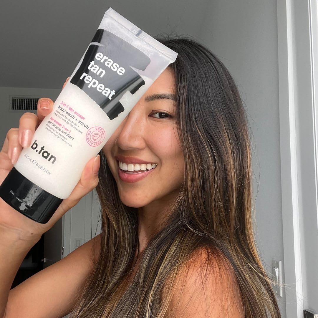 B.TAN bottle next to a hand demonstrating 8 fl oz scale for size reference
